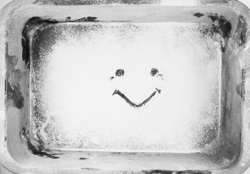 Drawing made by hand by sprinkled flour on a oven-tray