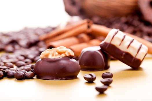 collection of different chocolate pralines truffels on golden brown background macro