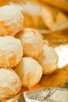 collection of different chocolate pralines truffels on golden brown background macro