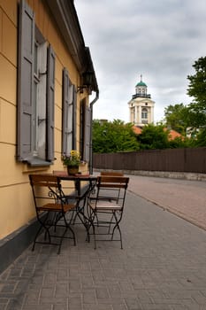 little table and chairs on a street