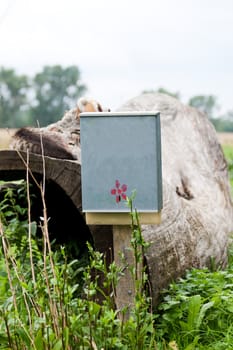 rural postal mailbox attached to a wooden post 