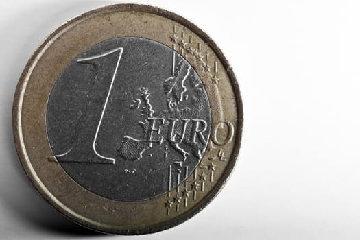 1 Euro coin macro detail over plain white backdrop