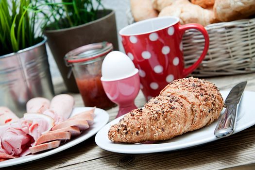 traditional french breakfast in morning on wooden background