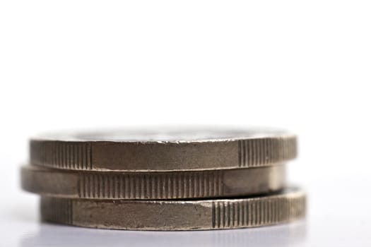 Stack of three 1 Euro coins over a plain background
