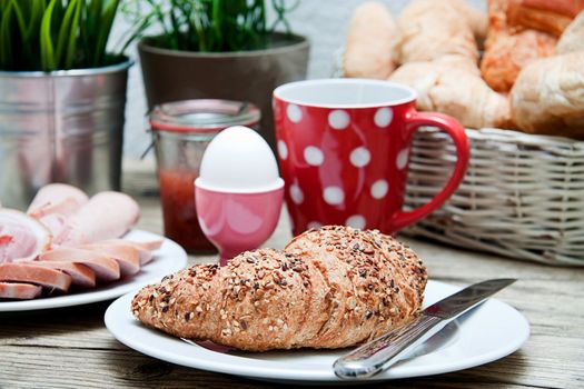 traditional french breakfast in morning on wooden background