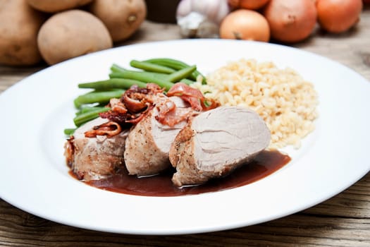 deliscious hot filet and greend beans on plate serving on wooden table