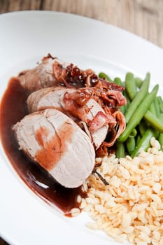 deliscious hot filet and greend beans on plate serving on wooden table