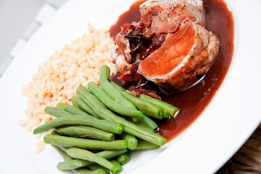 deliscious hot filet and greend beans on plate serving on wooden table