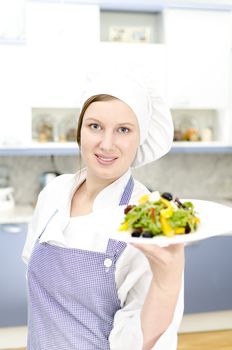 Pretty cook chief holding salad