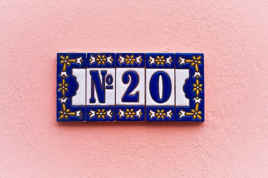 house number on pink wall