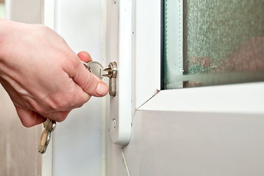 hand locking a door