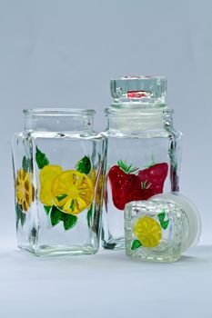 Empty decorative glass food container on bluish background