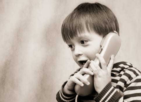 little boy talking on the phone