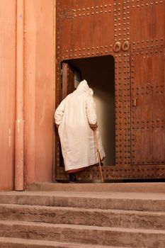 moroccan man entering mosque