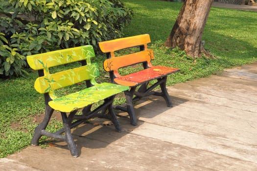 Two wooden chairs in a park