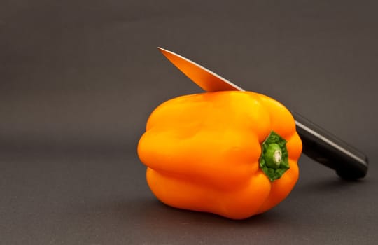 orange bell pepper and knife