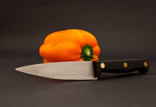 orange bell pepper and knife