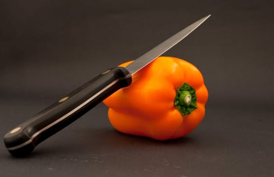 orange bell pepper and knife