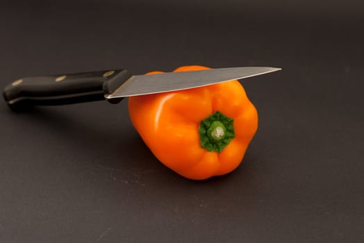 orange bell pepper and knife