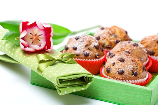 muffins with a serviette, in a tray for breakfast. isolated on white background.