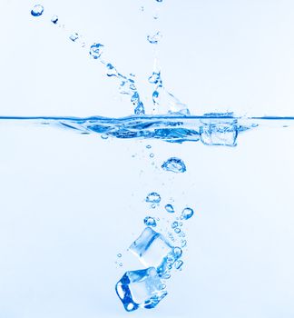 Ice Cubes Dropped into Water with Splash on white