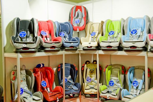 Children's automobile armchair in th shop of the children's goods