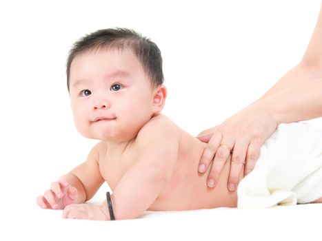 Baby massage.  Asian mother massaging baby. Isolated on white background