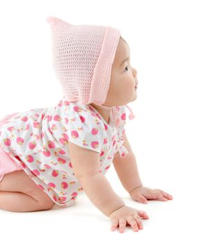 Six months old East Asian baby girl crawling on white background
