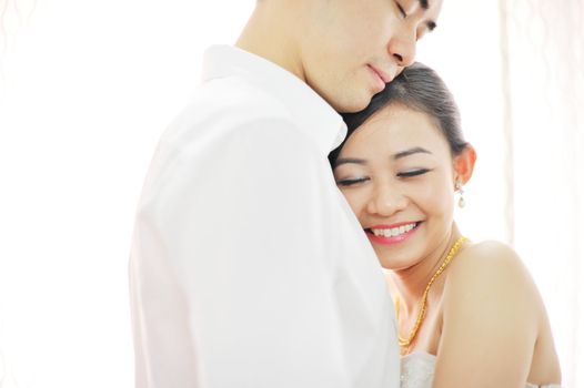 Asian Chinese wedding couple in love. Romantic groom and bride dancing in their wedding day