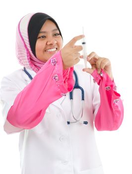 Muslim female medical doctor filling the syringe getting ready for a medical procedure, isolated on white background