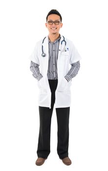 Full body southeast Asian medical doctor. Male medical doctor standing on white background with confident smile.