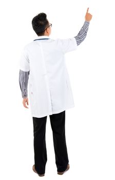 Full body rear view of Asian medical doctor pointing at blank space standing isolated on white background
