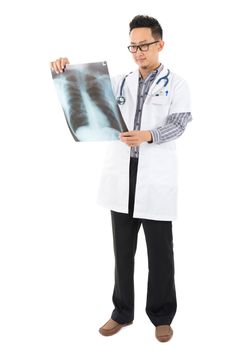 Full body Asian medical doctor checking on x-ray image standing isolated white background