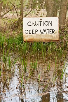 deep water sign in flooded woodland