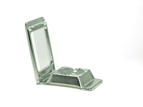 chrome metal egg slicer on white background