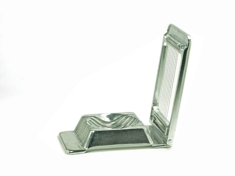 chrome metal egg slicer on white background