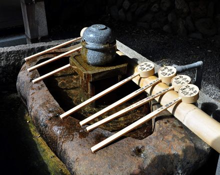 Tsukubai - Ladles used for cleaning hands at Japanese Temples, Fushimi Inari, Kyoto, Japan 