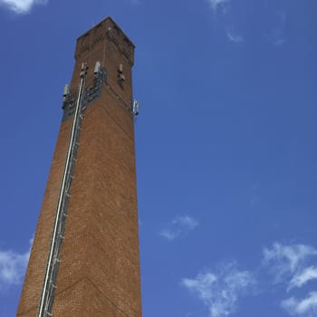 Brick industrial chimney and blue sky