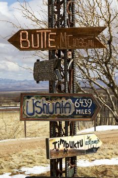 Directional signs point to distant places; location is Dragoon Mountains in Arizona; 