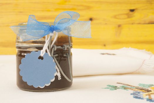 jam jar with blank label for text, tablecloth and napkin