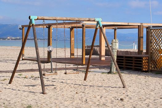 wood swings on the beach