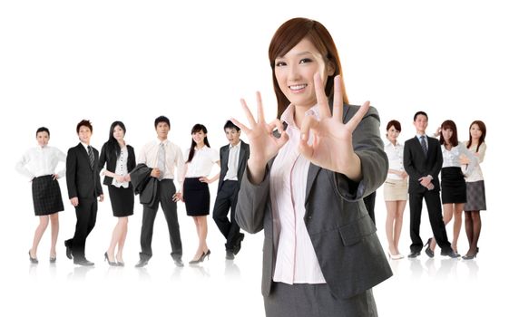 Smiling business executive woman of Asian give you an okay sign in front of her team isolated on white background.