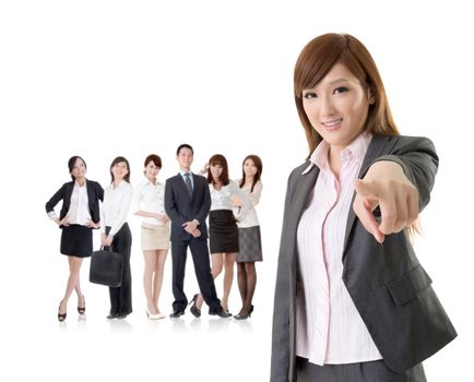 We want you, Asian business woman point at you in front of her team isolated on white background.