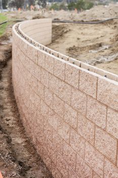 Curved New Outdoor Retaining Wall Being Built at Construction Site.