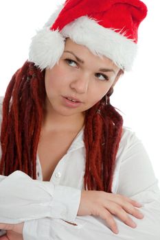 Portrait of young modern girl wearing Santa Claus hat isolated on white background.