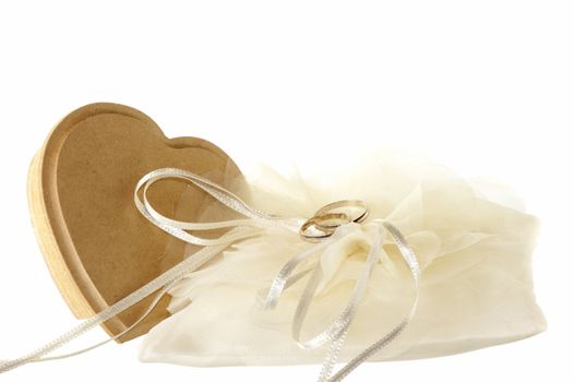 wedding favors and wedding rings on white background