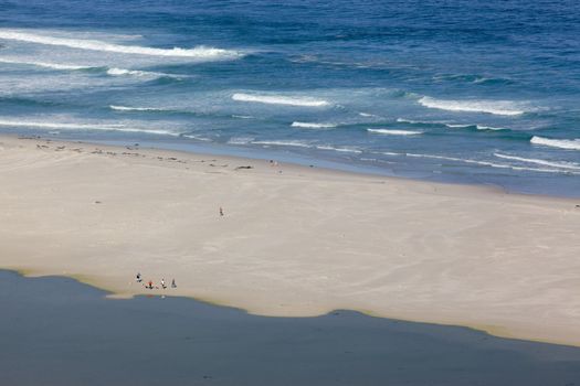 People relaxing at Long Beach in the Cape Peninsula, South Africa.