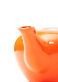 Part of Orange Ceramic Teapot closeup on white background