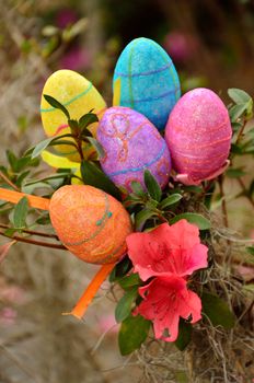 Styrofoam Easter eggs decorate an azalea bush