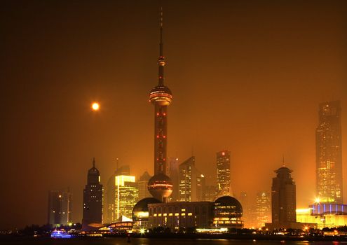 Shanghai Pudong Chna Skyline at Night with TV Tower with Moon and Reflections
Orange Haze

Trademarks removed.

Trademarks removed.